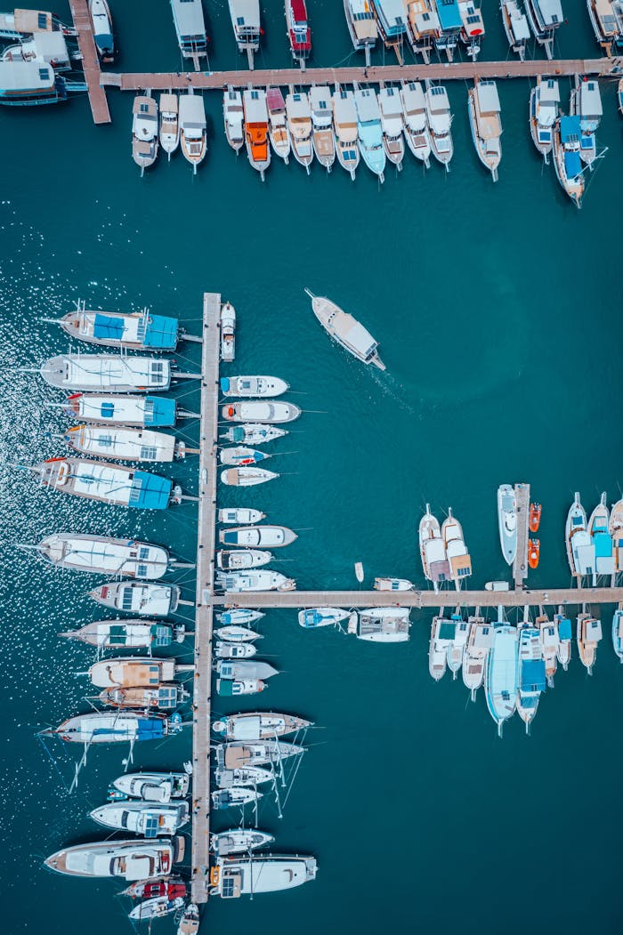 service-03 Drone capture of yachts and boats moored at a serene Antalya harbor, showing an organized vertical display.
