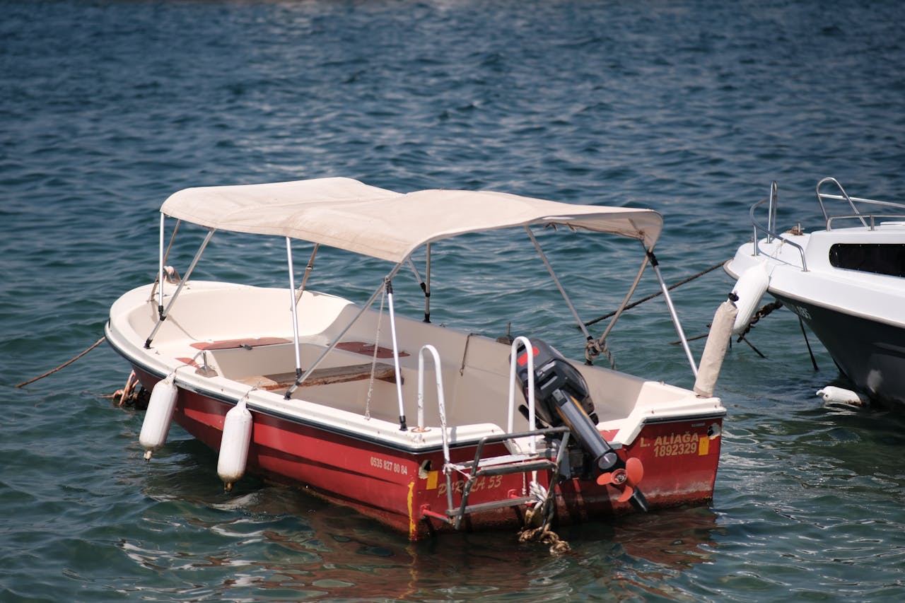 service-01 A small fishing boat with a canopy moored on the beautiful waters of Foça, İzmir.